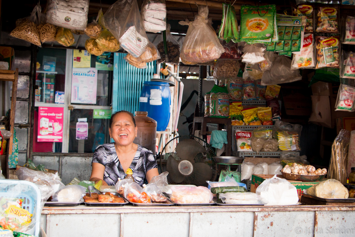 Faces of Asia: Laughing vendor at the market in Vietnam